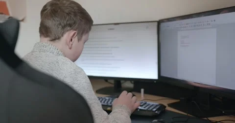 Kid Boy Use Desktop Computer for Study Typing and Reading. 4K 10-bit Stock Footage 336672861