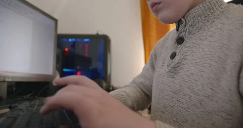 Kid Boy Use Desktop Computer for Study Typing and Reading. 4K 10-bit Stock Footage 336672880