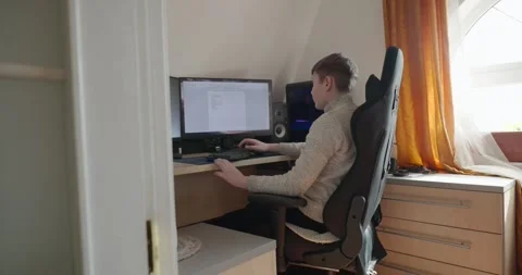 Kid Boy Use Desktop Computer for Study Typing and Reading. 4K 10-bit Stock Footage 337949234