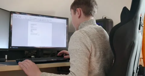 Kid Boy Use Desktop Computer for Study Typing and Reading. 4K 10-bit Stock Footage 337949267