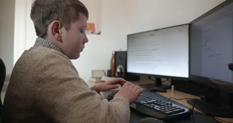Kid Boy Use Desktop Computer for Study Typing and Reading. 4K 10-bit Stock Footage 339065544