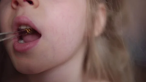 Kid brushes his teeth with an electric toothbrush. Stock Footage 107929104