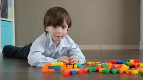 Kid Builds a Wall of Plastic Designer Stock Photos
