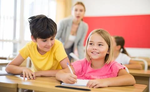 Kid cheating during test Stock Photos
