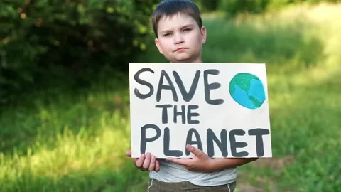 Kid child looking to camera with save planet ecology poster in hands. school  Stock Footage 134966475