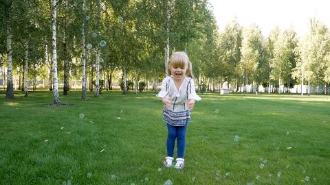 Kid child trying to catch eat soap bubbles with tongue. Candid portrait of cute Video stock 99233052