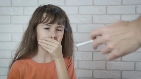 choking on a cigarette The kid is choking on cigarette smoke