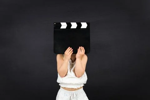 Kid with clapper board Stock Photos