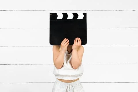 Kid with clapper board Stock Photos