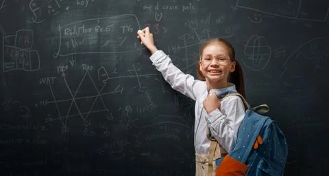 Kid in class on background of blackboard Stock Photos