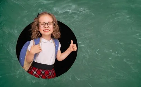Kid in class on background of chalkboard. Stock Photos