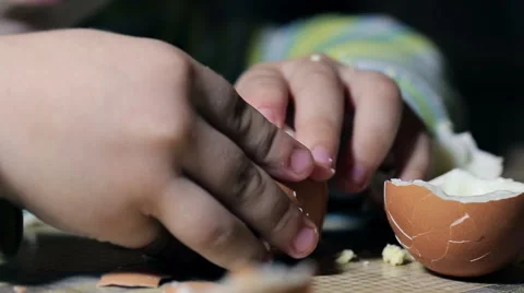 Kid cleans separates egg Stock Footage 58600707