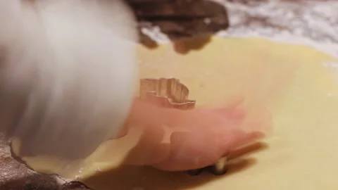 Kid covers dough with cookie cutters Stock Footage 239067220