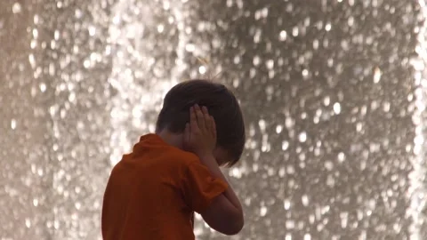 Kid covers his ears with hands to protect from noise. Denial conception. Child Stock Footage 138631214