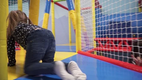 Kid crawling through children's maze in play center Stock Footage 102268912