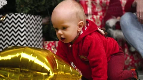 The kid is crawling towards a large yellow balloon. New Year. Holiday. Stock Footage 165779663