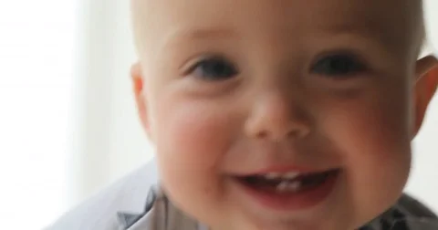 Kid crawls to camera smiles six teeth close-up Video stock 77334514
