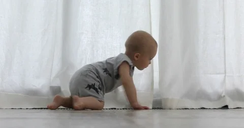 Kid creeps to the window and opens the curtains Video stock 77412616