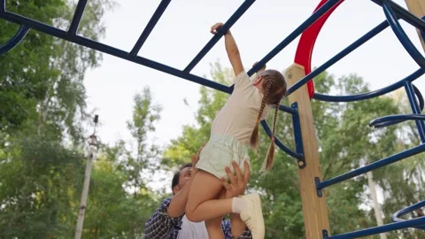 Kid, dad is having fun on playground. Family, child, dad play together on 스톡 동영상 241915869