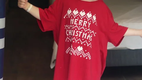 Kid dancing in red t shirt with merry christmas words vacation Video stock 219736224