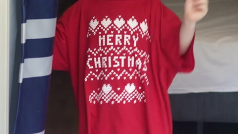Kid dancing in red t shirt with merry christmas words vacation Stock Footage 219736246