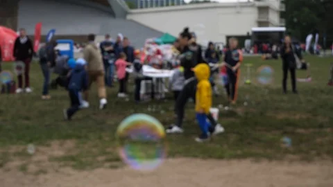 Kid destroying bubbles in the bubble festival Stock Footage 109499652