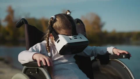 Kid with disability plays computer game using VR headset Stock Footage 237717857