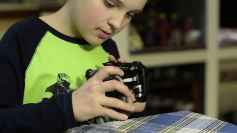 Kid dissembles a remote control Stock Footage 102384150