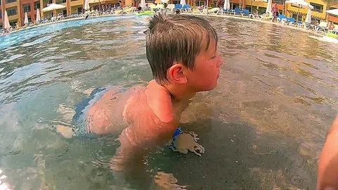 Kid dives into a pool Stock Footage 75451523