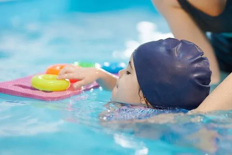 Kid do swim exercise in lessons classes Stock Photos