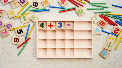Kid doing addition equation using counting rods Stock Footage 114190391