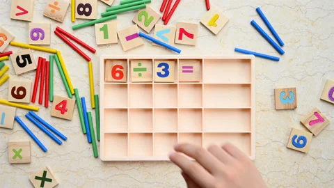 Kid doing division equation using counting rods Stock Footage 114188761