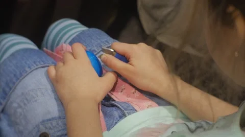 Kid is Doing Easter Egg Cutting Out an Ornament Holding a Blue Egg at Family Stock Footage 61336564