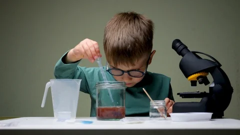 Kid doing experiments. Alternative education. Leisure activity indoors. Child Stock Footage 119359935