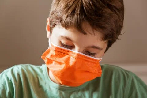 Kid doing homework or working in classroom with surgical mask 写真素材