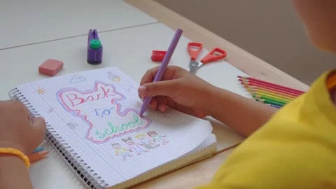 Kid drawing back to school on a notebook Stock Footage 279337728