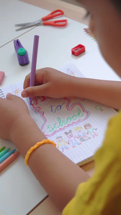 Kid drawing back to school on a notebook Stock Footage 279337759