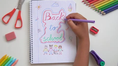 Kid drawing back to school on a notebook Stock Footage 279337786