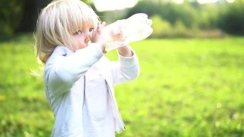 Kid drinks water from a bottle. Stock Footage 80833176