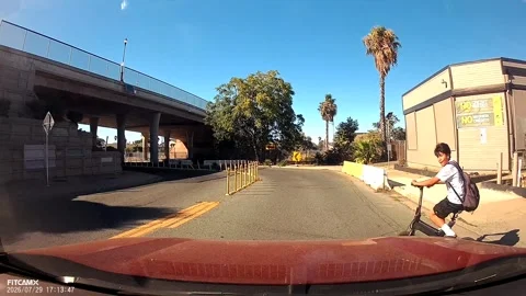 Kid on E-Bike Darts Directly in Front of Moving Car, Pittsburg, California, USA  Stock Footage 344685031