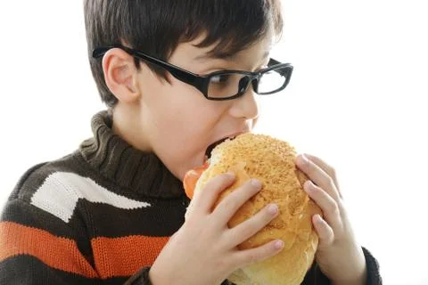 Kid eating bread bun Stock Photos