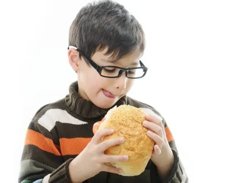 Kid eating bread bun Foto stock