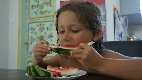 Kid eating a slice of watermelon Stockbeeldmateriaal 104981537