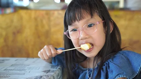 Kid eating Slomo1 Stock Footage 131872047