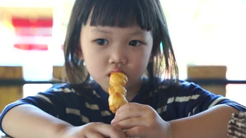 Kid eating Slomo2 Stock Footage 131872150