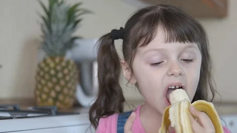 The kid eats a banana. Stock Footage 106467285
