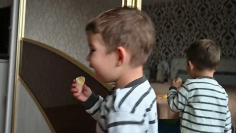 The kid eats a banana, makes faces and dancing. Stock Footage 172590914