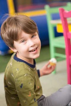 A kid eats a cupcake. Stock Photos