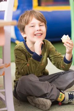 A kid eats a cupcake. Stock Photos