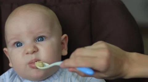 Kid eats first meal Stock Footage 47324491